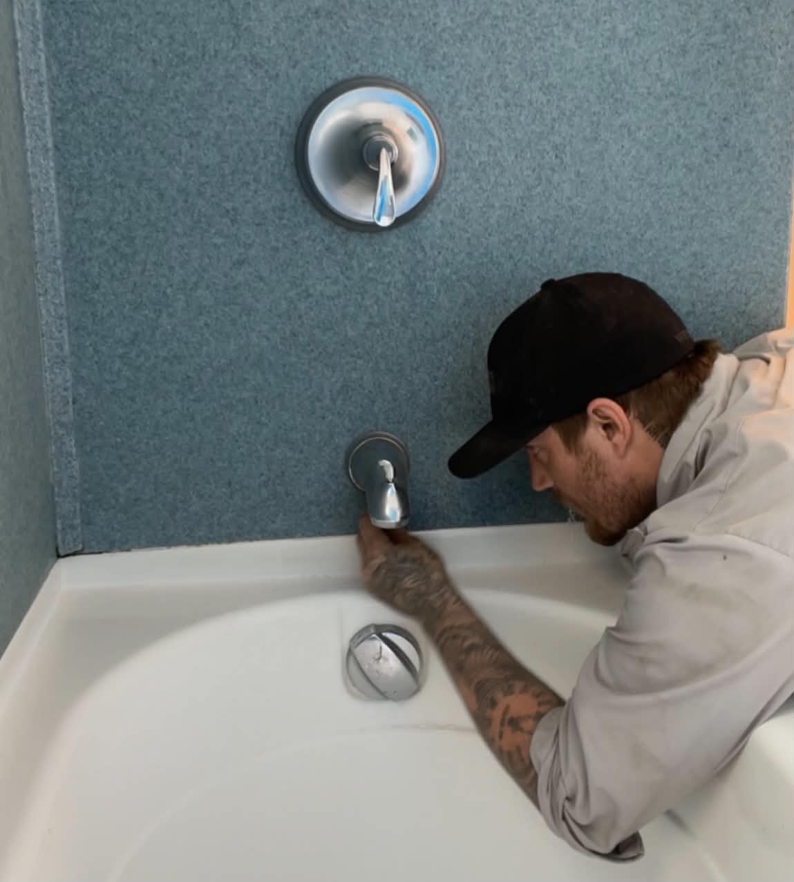 Snape's Services plumber installing a bathtub fixture