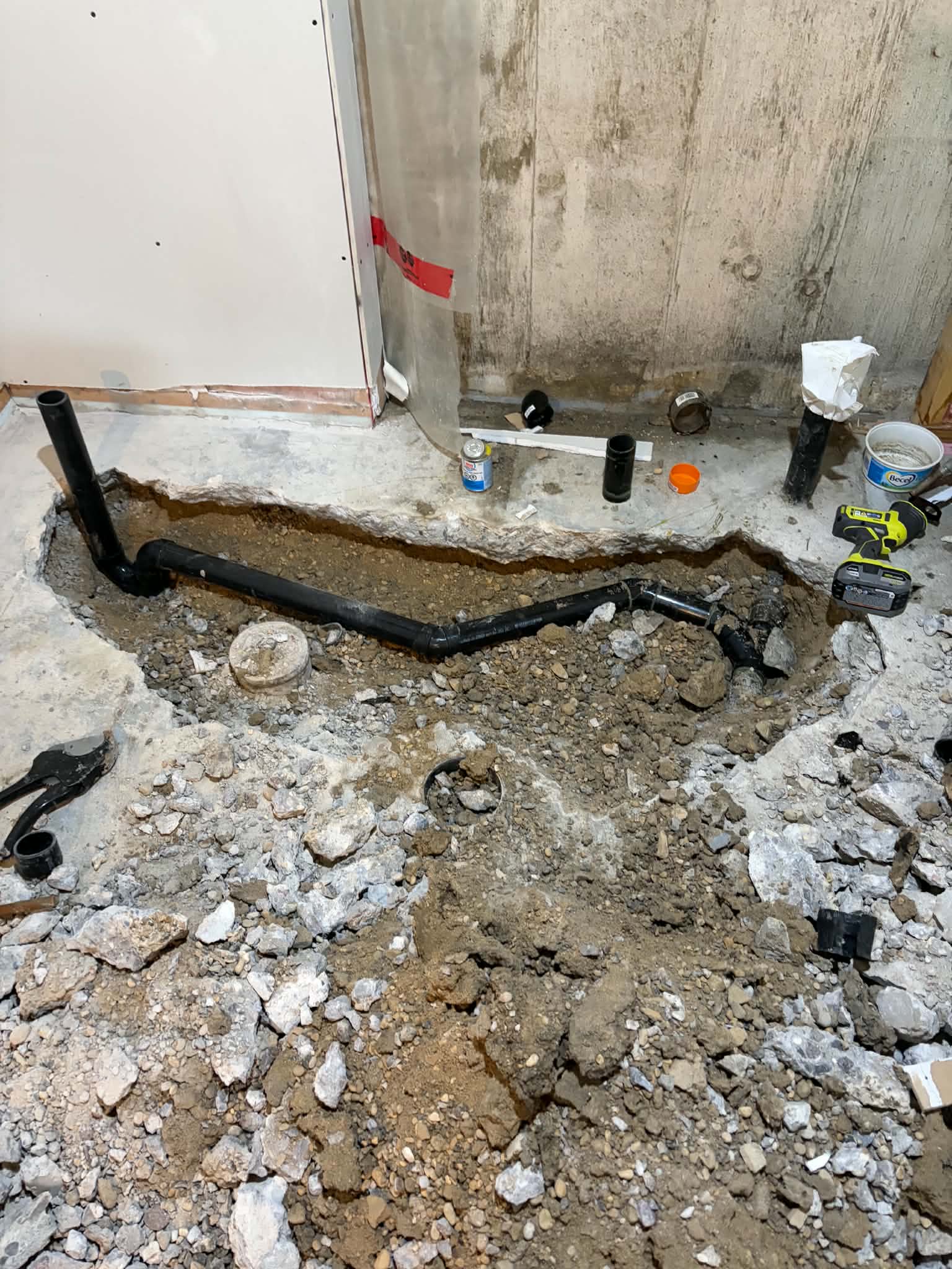 Underground drain piping installed below a concrete floor